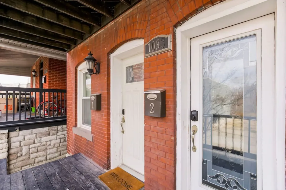 This image presents the inviting brick facade of the property, featuring decorative doors and a welcome mat. It captures the first impression guests will have upon arriving and the sense of arrival experienced before heading out to nearby sports, concert, or casino events.